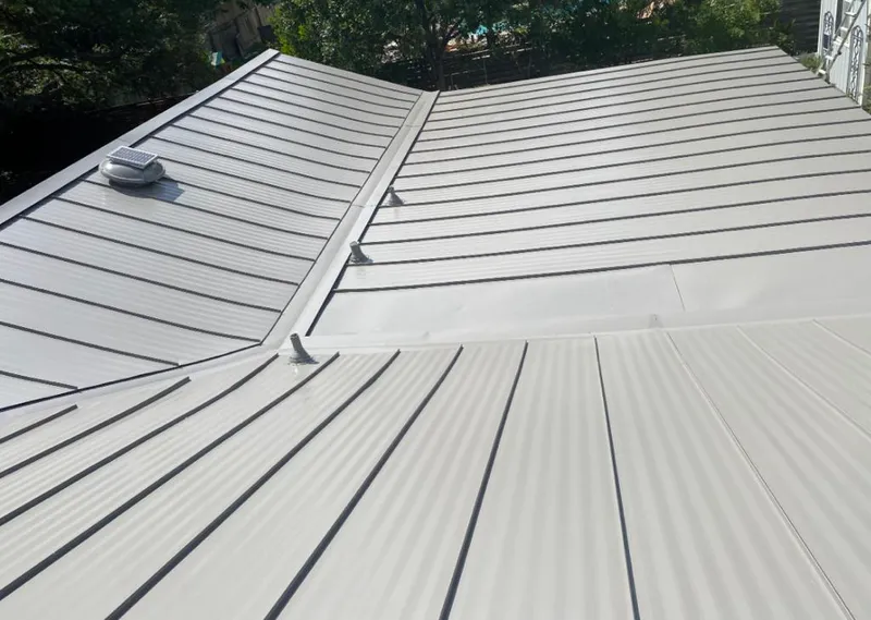 Solar attic fan installed on a metal roof for Roof Ventilation in Battle Creek